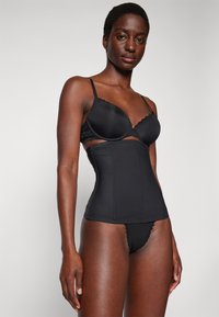 Black bra and high-waisted shapewear with a smooth texture. The bra features lace accents, while the shapewear has structured seams.