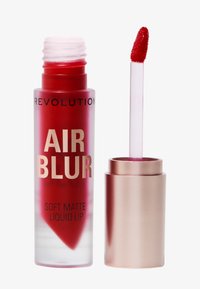 Rouge à lèvres liquide mat doux en emballage cylindrique transparent avec des lettres dorées et un applicateur rose.