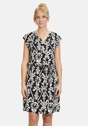 Schwarz-weiß gemustertes Kleid mit kurzen Ärmeln, V-Ausschnitt, verstellbarem Taillenzug und einem entspannten Schnitt.