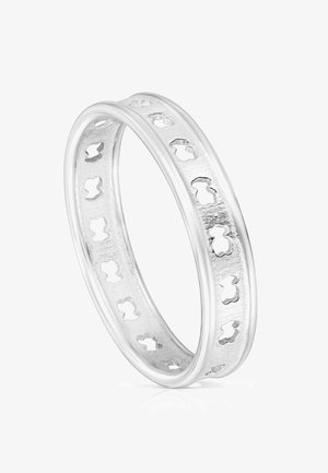 Silver ring featuring an intricate cutout pattern along the band, smooth polished edges, and a textured inner surface.