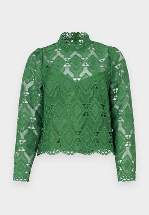Zielony koronkowy top z długimi rękawami, wysokim dekoltem i materiałem w diamentowy wzór. Szczegółowe falbany u dołu oraz złożony wzór wycięć.