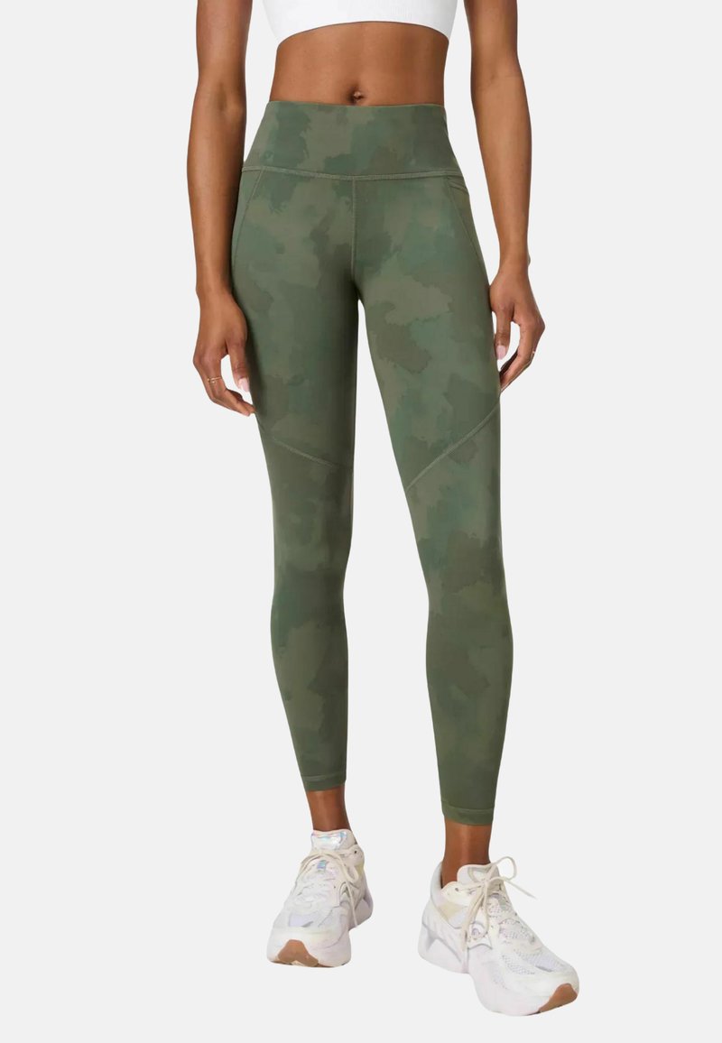 High-waisted, olijfgroene sportleggings met een camouflagepatroon, voorzien van gladde naden en een soepel, rekbaar materiaal voor comfort.