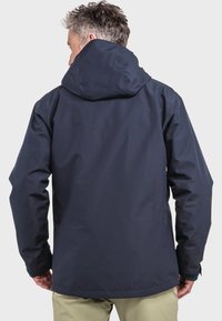 Marineblauer wasserdichter Jacke mit Kapuze, strukturiertem Stoff und verstellbaren Bündchen. Entworfen für Outdoor-Aktivitäten. Verfügt über einen geraden Schnitt.