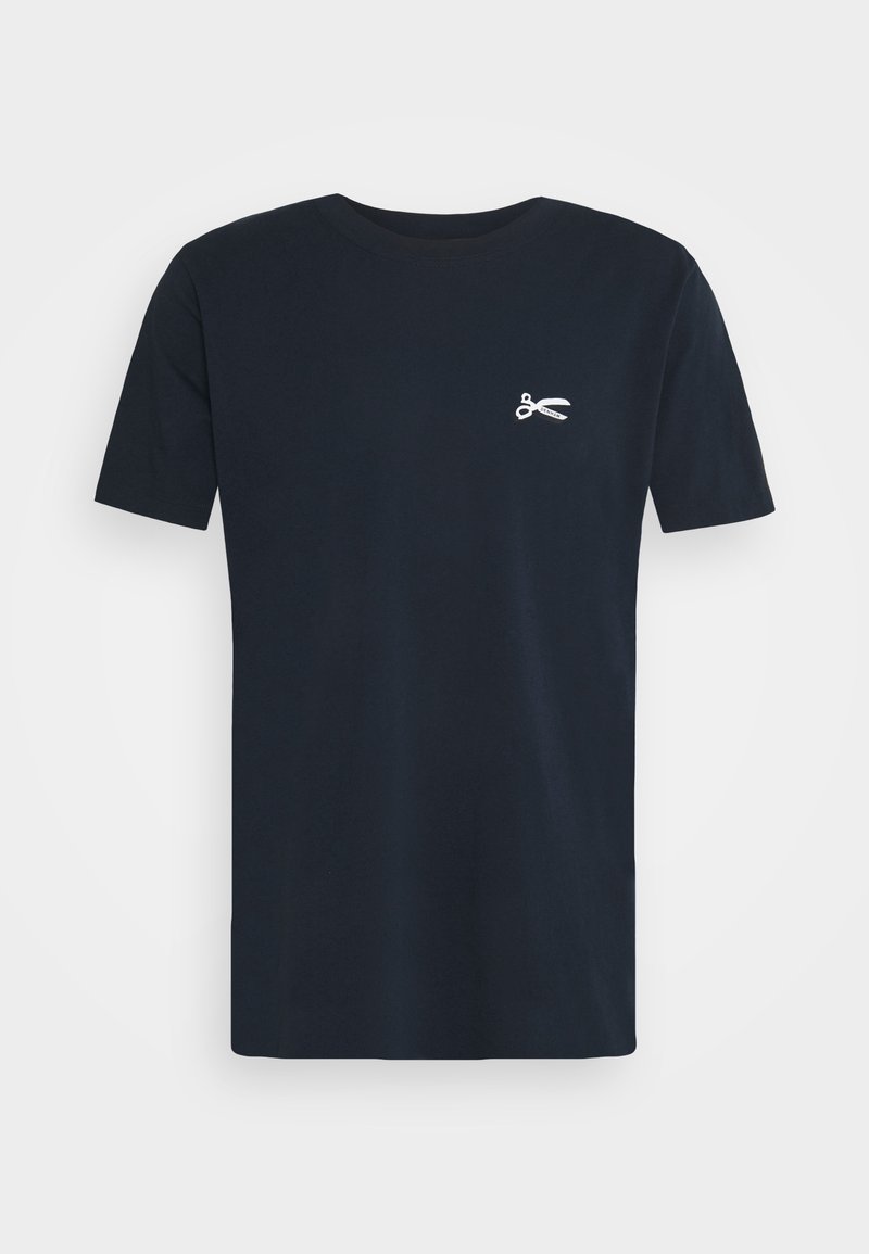 T-shirt noir à manches courtes avec col rond, orné d'un petit motif de ciseaux blancs sur le côté gauche de la poitrine, présenté sur un fond uni.