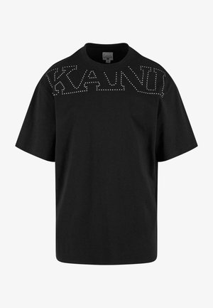 T-shirt en coton noir avec une coupe loose, des manches courtes et le mot "KANUT" souligné de clous en argent sur la poitrine.