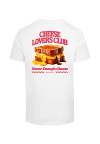 White cotton t-shirt featuring a graphic of two toasted bread slices with melted cheese, text above: "CHEESE LOVERS CLUB," below: "Never Enough Cheese, Since 2024."