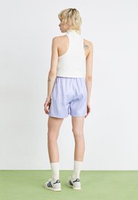 adidas Originals FASHION MONOGRAM - Tracksuit bottoms - violet tone
