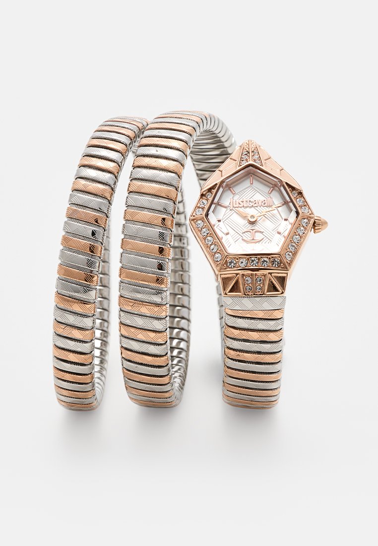 Sechseckige Uhr mit einem Armband aus Roségold und Silber, das geometrische Muster und Kristallakzente auf der Lünette aufweist, einem weißen Zifferblatt und silbernen Zeigern.