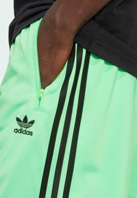 adidas Originals FIREBIRD - Tracksuit bottoms - screaming green   black