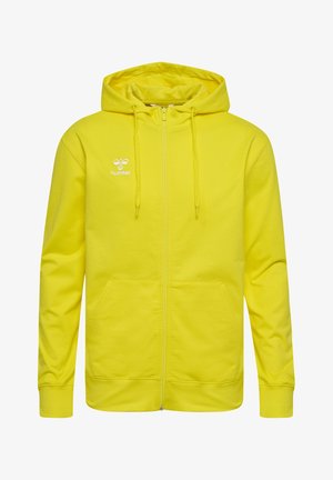 Sweat à fermeture éclair jaune en tissu doux, doté d'une capuche, de poches avant et du logo "Hummel" brodé en blanc sur la poitrine.