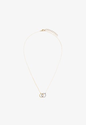 Delikatny złoty naszyjnik z dwoma połączonymi okrągłymi zawieszkami, jedną złotą i jedną srebrną, oraz regulowanym zapięciem.