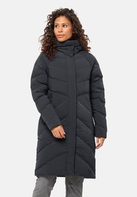 Long black puffer coat with a high collar and chevron quilted pattern. Features long sleeves and a straight cut, made of lightweight synthetic material.