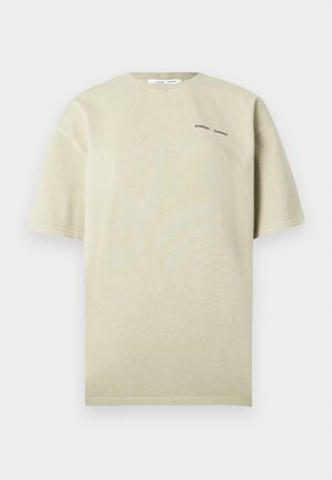 Hellbeiges, übergroßes T-Shirt aus weicher Baumwolle. Verfügt über kurze Ärmel, einen Rundhalsausschnitt und ein kleines schwarzes Textlogo auf der Vorderseite.