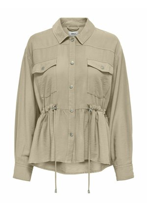 Chemise crème à manches longues avec un col, poches poitrine, taille élastiquée et fermeture à boutons sur le devant. Tissu doux et léger.