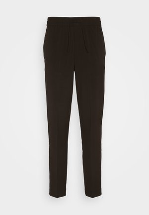 Pantalons noirs, longs et fuselés fabriqués à partir d'un matériau doux et lisse. Dotés d'une taille élastique avec un cordon de serrage pour un ajustement réglable.