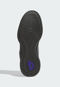 Semelle de chaussure en caoutchouc noir avec un motif de semelle texturé. Présente un logo violet sur le talon. Forme arrondie avec une finition lisse sur les bords.