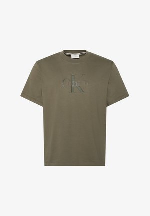 T-shirt vert olive à manches courtes et col rond, avec logo en relief "ck" Calvin Klein centré sur la poitrine.