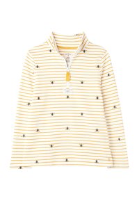Suéter blanco con rayas amarillas, con pequeñas abejas bordadas. Cuello de media cremallera y una etiqueta con el logo en el frente. Material de algodón suave.
