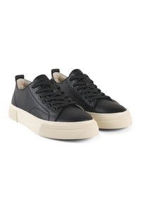 Sneaker in pelle nera con punta tonda, chiusura con laccio sul frontale e suola in gomma crema a contrasto. Texture liscia con dettagli di design minimalisti.