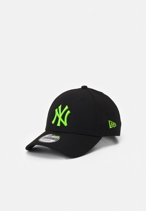 Black New York Yankees baseball cap with bright green logo and side emblem, curved brim, and adjustable strap.