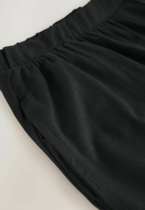 Mustat joustavat vyötäröhousut, jotka on valmistettu sileästä, venyvästä kankaasta. Ominaisuuksiin kuuluu kerätty vyötärö ja sivutaskut, yksinkertainen ja siisti muotoilu.