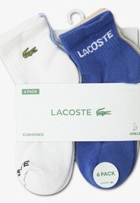 Six-pack of ankle socks in white and blue. Features Lacoste logo and crocodile emblem. Made with cushioned material.