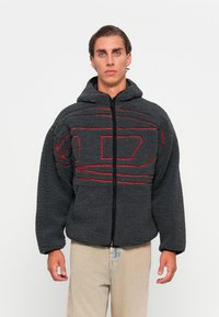 Gray fleece jacket with a hood, featuring red line patterns. Zippered front closure, wide sleeves, and a soft, textured material.