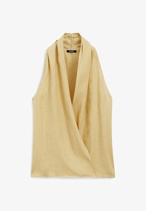 Tílková halenka z lehkého béžového lněného materiálu s překládaným designem a vysokým límcem. Hladká textura s minimálním šitím.