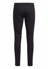Jeans negros ajustados con una textura suave, con una cintura de altura media, dos bolsillos traseros y un corte slim hasta el tobillo.