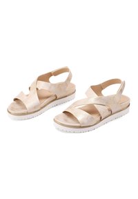 Sandali in tono oro con design incrociato e punta aperta. Presentano soletta imbottita e una suola piattaforma bianca con battistrada testurizzato.