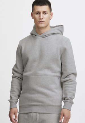 Gray hooded sweatshirt in soft fabric with a relaxed fit, featuring a kangaroo pocket and cuffed sleeves for comfort.