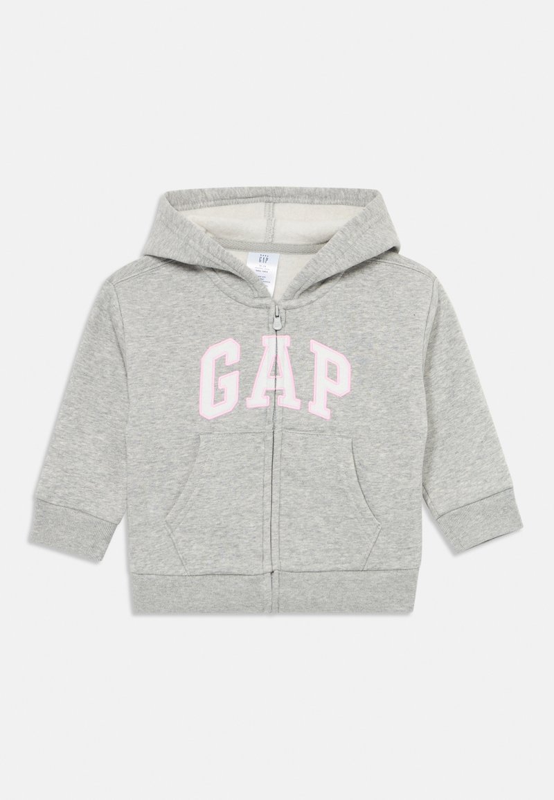 Svetlošedá detská mikina s kapucňou, na zips, s dvoma prednými vreckami a ružovým logom GAP na hrudi.
