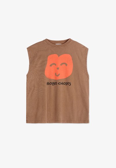 Brown sleeveless shirt with a large orange smiling face logo. Features soft cotton fabric and a relaxed fit, with "BOBO CHOSES" printed below.