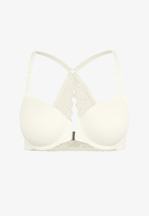 Bra imbottito bianco con dettagli in pizzo, spalline incrociate e una chiusura decorativa. Tessuto liscio con accenti di pizzo intricati.