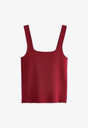 Punane ribaga ükstehase T-särk, millel on ruudukujuline kaelus ja laiad rihmad. Hem on kaunistatud sakiliste servadega. Valmistatud pehmest ja venivast kangast.