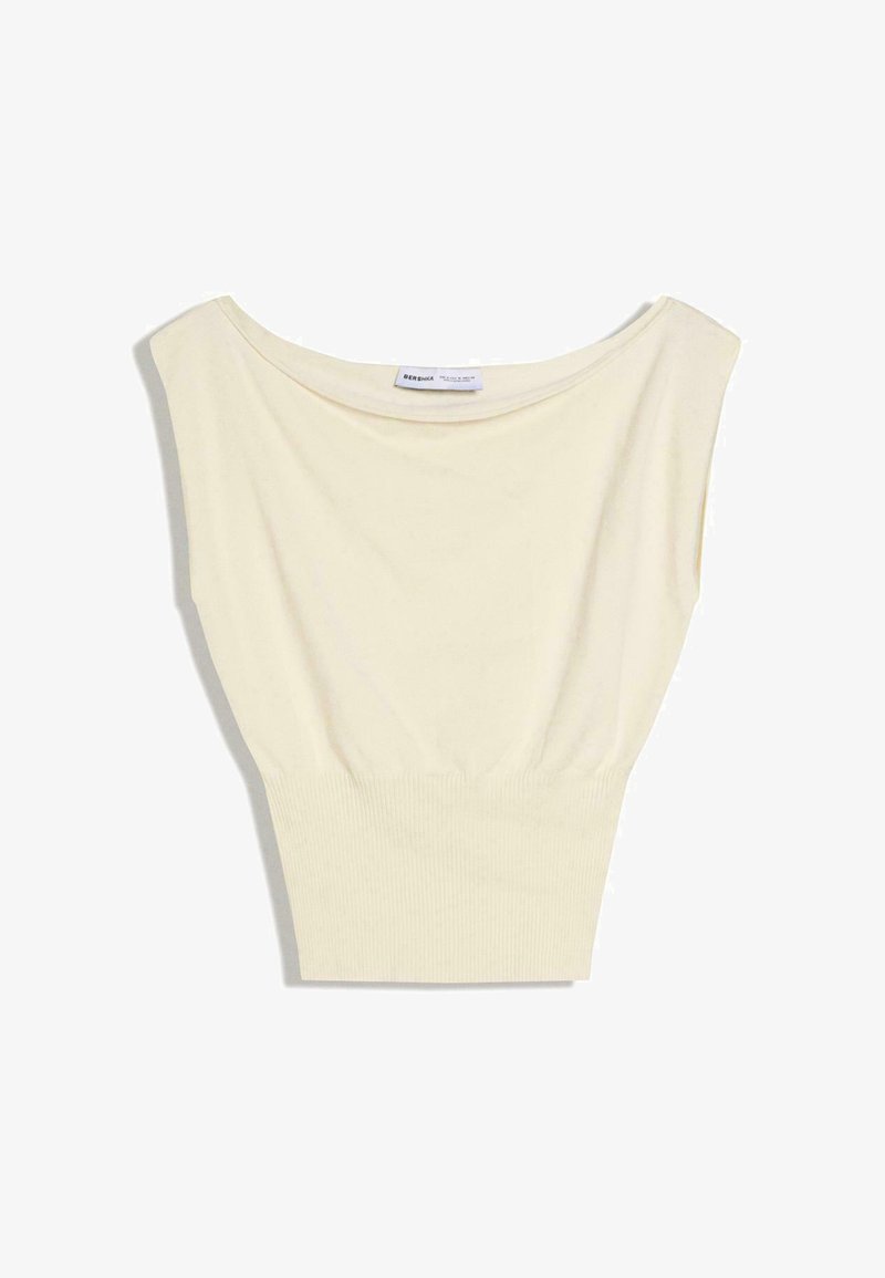 Top tricotat crem fără mâneci, cu decolteu larg și talie cu dungi, așezat pe o suprafață plată pe fundal alb.