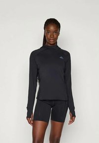 Long-sleeve black athletic top with a hood, featuring a blue logo. Paired with black shorts, both made from smooth, stretchy material.