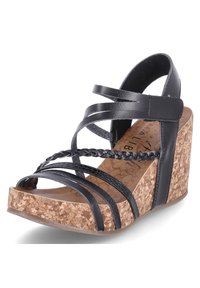 Sandale compensée noire avec brides tressées, plateforme en liège et tige en cuir lisse. Le design comprend plusieurs brides croisées et une fermeture à boucle.