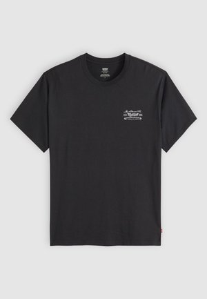 Black cotton t-shirt with short sleeves and a round neck. Features a small white graphic print on the left chest. Smooth texture.
