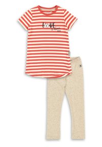 Striped red and cream short-sleeve T-shirt with "Love to Dream" print; paired with beige leggings featuring a speckled texture.