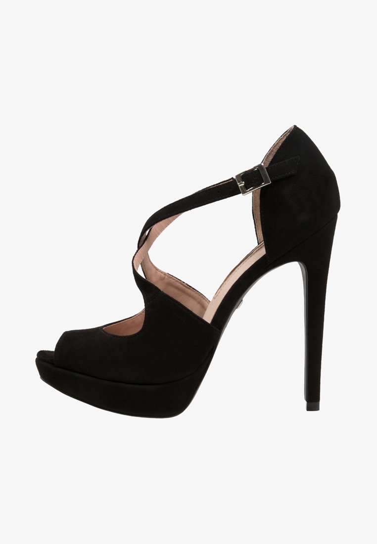 Sandale à plateforme noire à talons hauts, bout ouvert, bride de cheville croisée et boucle argentée sur une doublure intérieure beige clair.