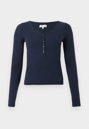 Navy blue ribbed long-sleeve shirt with a V-neck and four-button placket on front against white background.
