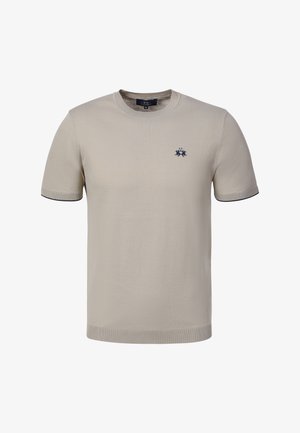 Beżowy krótki sweter z dzianiny z okrągłym dekoltem i małym, ciemnoniebieskim haftowanym logo na lewej piersi.
