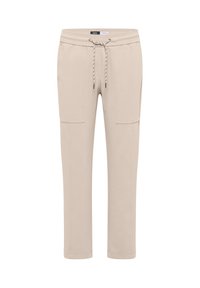 Pantalon de jogging beige en matériau doux, avec taille élastique, cordon de serrage et deux poches cargo sur les côtés.