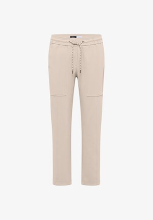 Pantalon de jogging beige en matériau doux, avec taille élastique, cordon de serrage et deux poches cargo sur les côtés.