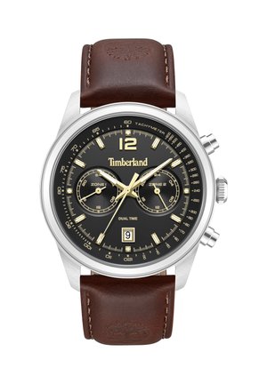 Timberland dubultā laika pulkstenis ar melnu ciparnīcu, zelta marķieriem, datuma logu, tahimetru, sudraba korpusu un brūnu ādas siksniņu ar uzspiestu logotipu.