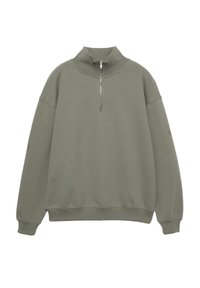 Felpa verde chiaro con collo alto, zip frontale a metà, polsini a coste e vestibilità rilassata. Tessuto morbido e texturizzato con dettagli minimi.