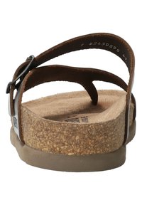 Sandale en cuir marron avec deux straps ajustables, semelle en liège et semelle extérieure en caoutchouc. La semelle intérieure présente une texture douce.