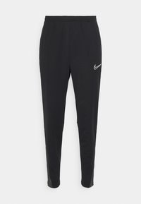 Pantalons de sport noirs en tissu léger avec une coupe slim. Dotés d'une taille élastique et d'un logo Nike blanc sur le côté gauche.