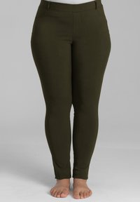 Olijfgroene leggings met een gladde textuur, met een strakke pasvorm, elastische tailleband en zonder zichtbare patronen of hardware.